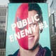 A giant electronic billboard labels Spider-Man and Peter Parker's faces as Public Enemy #1.